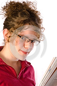 Girl in glasses reads magazine