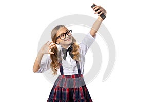 Girl in glasses records video reels on a smartphone, waves her hand, isolated on white.