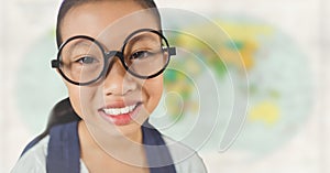 Girl with glasses smiling against blurry map