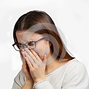 Girl with glasses sneezes selective focus isolate photo