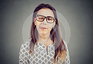 Girl in glasses sticking out tongue