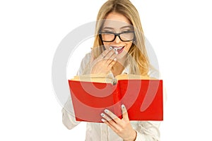 Girl in glasses and a white shirt reading a book