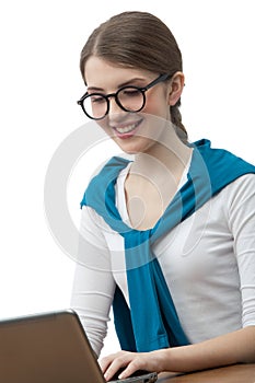 The girl in glasses works on computer