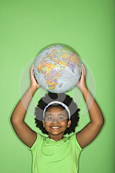 Girl with globe on head.