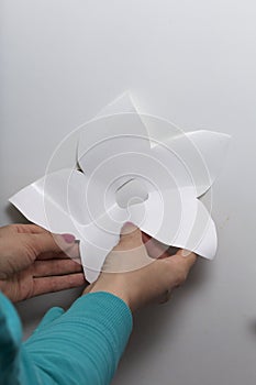 The girl glues the cut out elements from self-adhesive paper, to mask the defects of the white door.