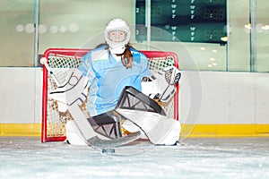 Girl goaltender crouches in crease to protect net