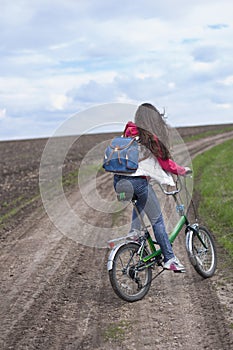 The girl goes on a bicycle