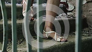 Girl goes down the stairs Inside an abandoned building. Half-ruined buildings in ghetto. Almost collapsed and ruined