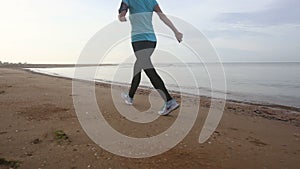 girl goes at jog trot along beach at sunrise