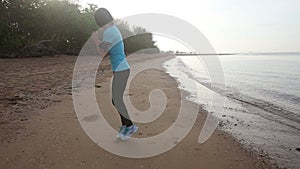 girl goes at jog trot along beach at sunrise