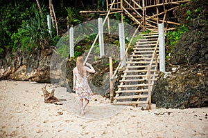 Girl goes to the bamboo ladder on the Boracay