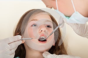 Girl going through dental examination