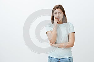 Girl going panic unsure what do. Portrait of anxious timid girlfriend in casual outfit frowning whining and biting