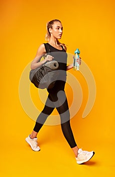 Girl Going To Gym Holding Bag And Water Bottle, Studio