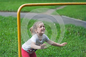 The girl is going to jump onto the crossbar.