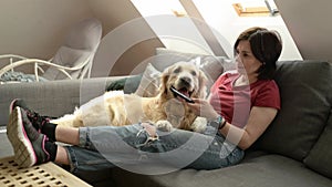 Girl with golden retriever dog at home