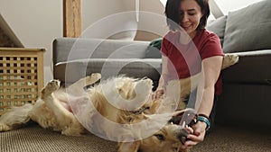 Girl with golden retriever dog at home