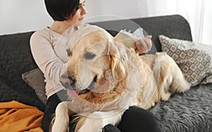 Girl with golden retriever dog reading book