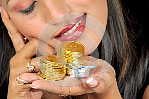 Girl with golden and silver coins