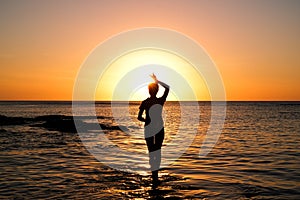 Girl at golden sunset at beach