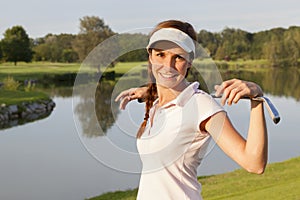 Girl golf player on golf course.