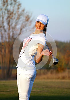 Girl golf player posing