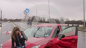 Girl got into car accident on the road in the heavy rain, she talks on the phone