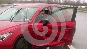 Girl got into car accident on the road in the heavy rain, she talks on the phone