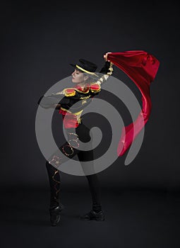 girl gracefully dancing in a stage costume stylized as a bullfighter