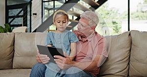 Girl, grandpa or tablet as gaming, app or technology as online, learning or fun on sofa in home. Happy, elderly man or