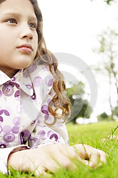 Girl on grass in park.