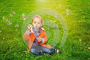 Girl grass soap bubbles