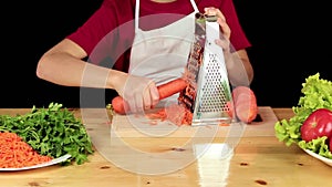 Girl grate and eating the carrots