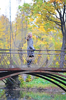 Girl in a gray coat in autumn park