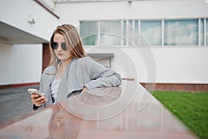 Girl in gray coat with sunglasses