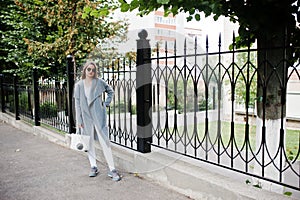 Girl in gray coat with sunglasses