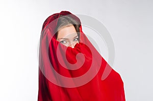 Girl with green eyes is hiding her face in a veil