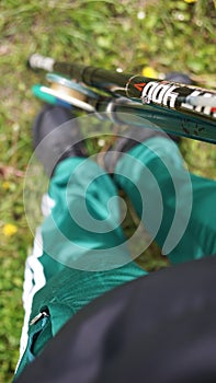 Girl in green pants and black sneakers and fishing rod