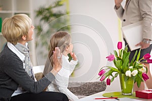 Girl greeting her mother and stay at home with her grandmother