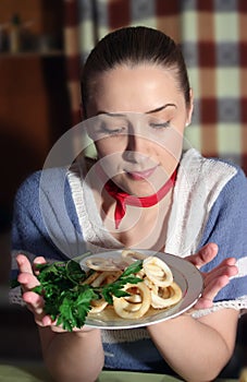 Girl with Grilled calamary in dish