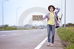 Girl with a guitar hitch-hiking
