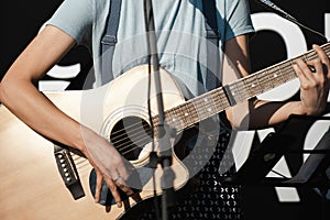 Girl with a guitar sings near the microphon