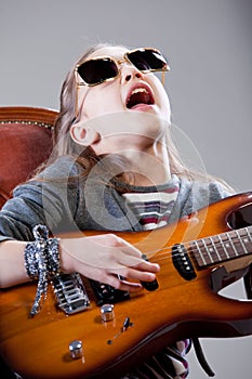 Girl with guitar and sunglasses