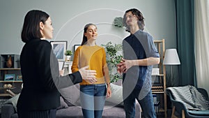 Girl and guy discussing new apartment with real estate agent talking indoors