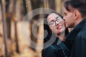 The girl and the guy are walking in the autumn forest