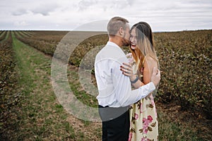 A girl and a guy are walking in the nature. Portrait of a couple, a love story.Happy smiling, loveing couple together outstretched