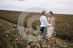 A girl and a guy are walking in the nature. Portrait of a couple, a love story.Happy smiling, loveing couple together outstretched