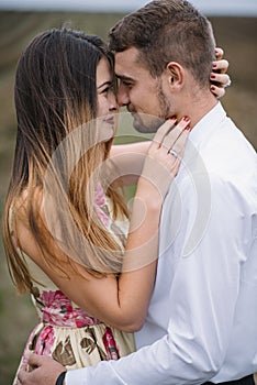 A girl and a guy are walking in the nature. Portrait of a couple, a love story.Happy smiling, loveing couple together outstretched