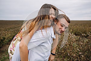 A girl and a guy are walking in the nature. Portrait of a couple, a love story.Happy smiling, loveing couple together outstretched