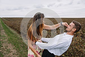 A girl and a guy are walking in the nature. Portrait of a couple, a love story.Happy smiling, loveing couple together outstretched